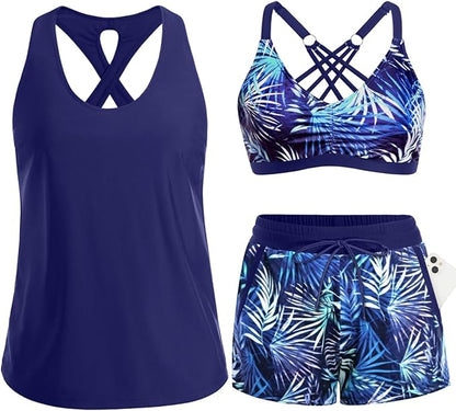 Flat-lay of a 3-piece athletic tankini swimwear set in navy blue and tropical palm leaf print.