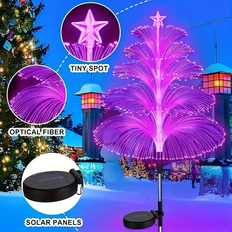 Close-up technical details of a pink tree-shaped solar fiber optic light, highlighting the star topper, optical fiber, and solar panels in a winter snow scene.