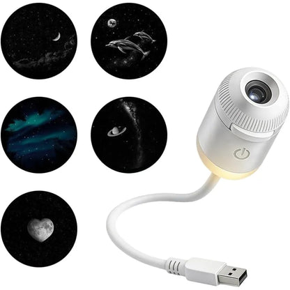 A white portable planetarium projector on a clean background, showcasing five switchable slides including crescent moon, dolphin, and northern lights aurora.