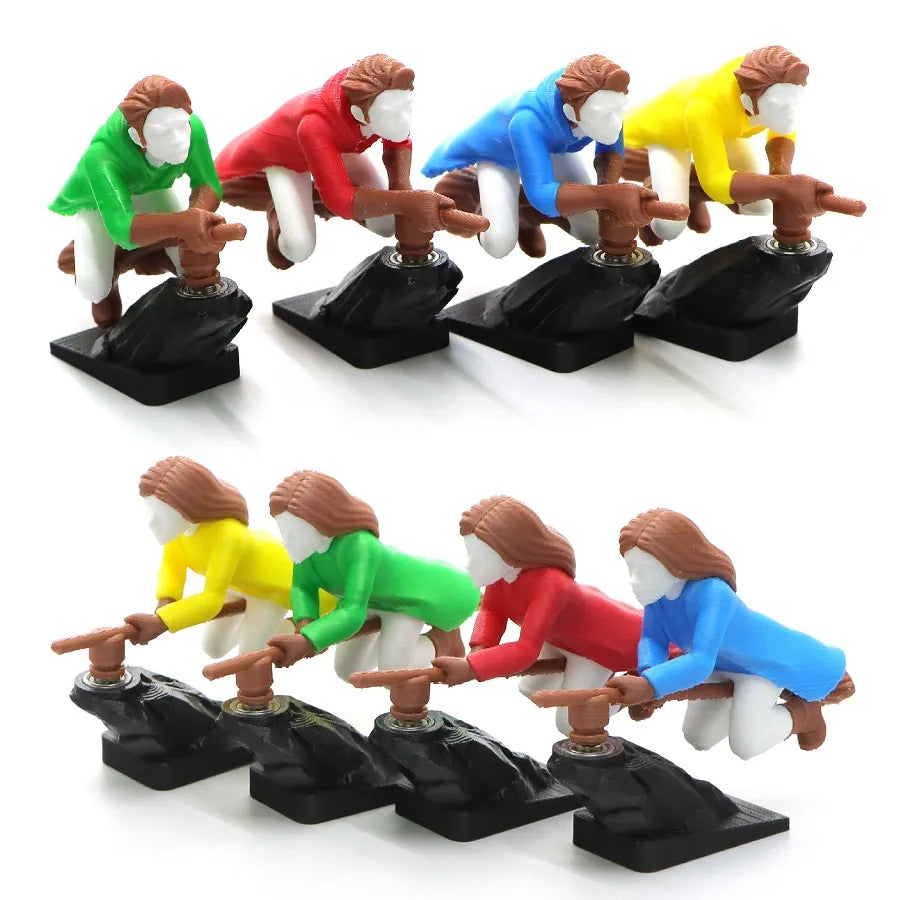 A collection of 3D-printed witch and wizard dashboard drift ornaments in yellow, green, red, and blue colors, shown on broomsticks with black bases.
